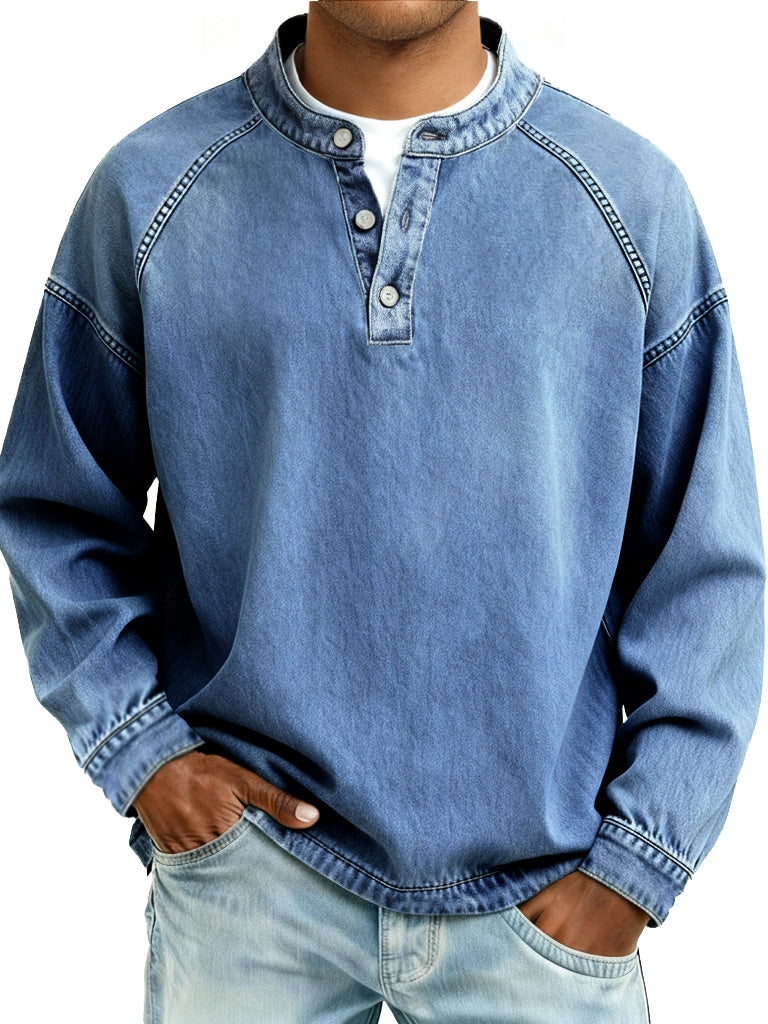 Person wearing a blue denim long-sleeve shirt with a white collar on a white background
